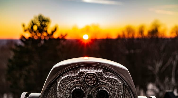 A telescope pointed at a sunset
